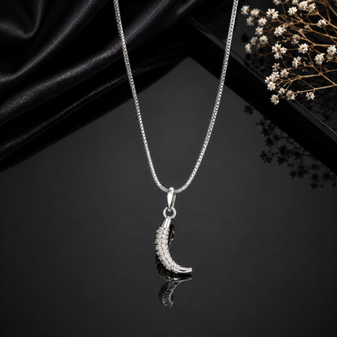 Elegant silver-tone crescent moon pendant necklace with sparkling stone detailing and sleek chain