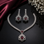 Elegant red stone American Diamond necklace and matching earrings set with sparkling silver-tone detailing