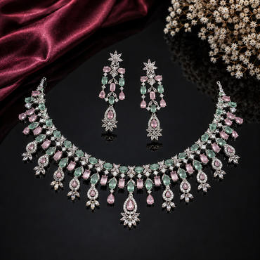 Elegant pastel pink and green American Diamond necklace set with floral detailing and matching earrings