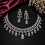 Elegant pastel pink and green American Diamond necklace set with floral detailing and matching earrings