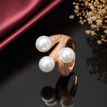 Elegant gold-tone triple pearl statement ring with three white pearl-style stones and textured band