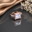 Elegant rose gold-tone rectangular CZ solitaire ring with sparkling halo detailing and stone-accented band