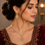 Elegant gold-tone American Diamond necklace set with sparkling floral detailing, statement pendant and matching earrings