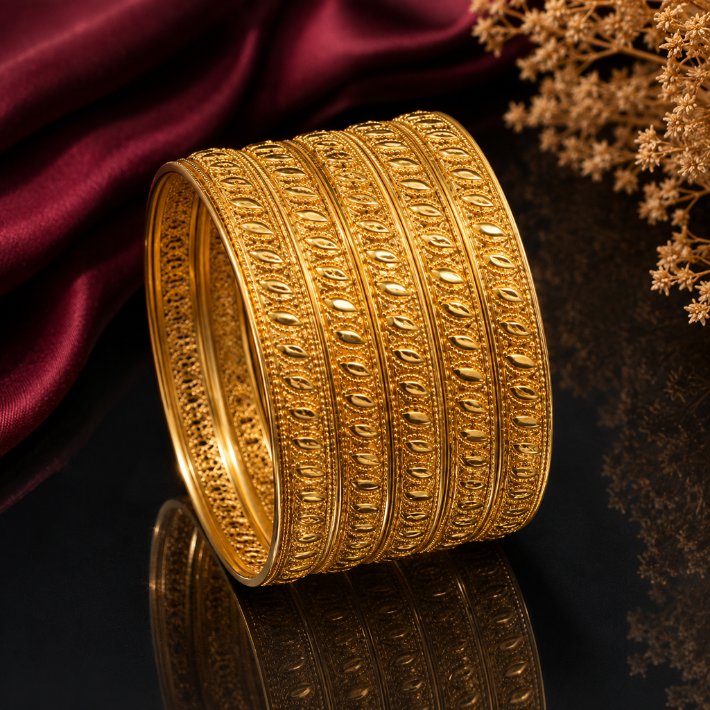 Elegant gold-tone traditional bangle set with intricate leaf pattern and textured detailing