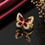 Elegant gold-tone red stone butterfly CZ ring with sparkling crystal detailing