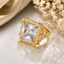 Elegant square-cut CZ crystal statement ring with brilliant center stone and sparkling gold-tone detailing