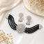 Elegant silver-tone pearl and crystal bridal necklace set with matching earrings and floral centerpiece