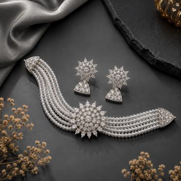 Elegant silver-tone pearl and crystal bridal necklace set with matching earrings and floral centerpiece