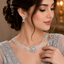 Elegant silver-tone pearl and crystal bridal necklace set with matching earrings and floral centerpiece