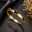 Elegant gold-tone butterfly motif bracelet with black butterfly accents and polished finish