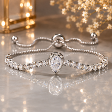 Silver tennis bracelet with pear-cut crystal centerpiece and round crystal chain, adjustable slider closure