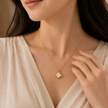 Elegant gold clover pendant necklace with white floral detailing