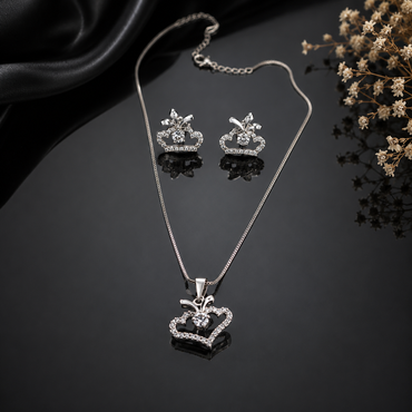 Elegant silver-tone crown pendant necklace and matching earrings with sparkling stones
