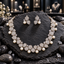 Silver-tone AD-style necklace with rounded clear-accent petal motifs and cream pearl-look drops, alongside matching double-petal earrings.
