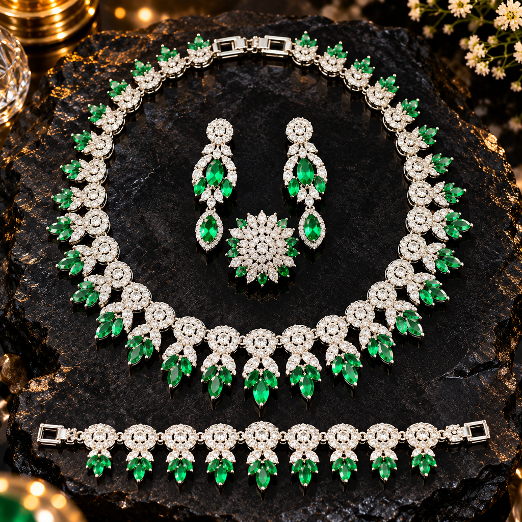 Emerald-green and silver-tone floral jewellery set with a necklace, drop earrings, bracelet and floral ring, decorated with clear sparkling accents.