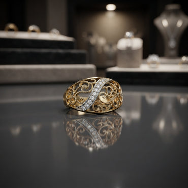 Gold-tone CZ pavé diagonal bar filigree scroll dome ring on reflective grey surface