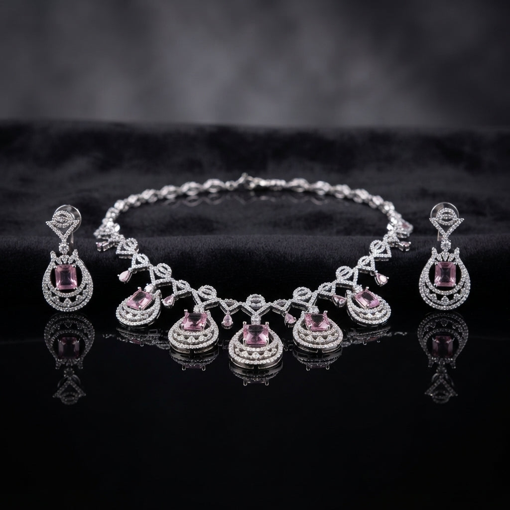 Silver Amethyst Purple CZ Emerald-Cut Teardrop Necklace and Drop Earrings Bridal Set — rhodium silver-tone 2-piece bridal set with 5-station graduating teardrop necklace featuring emerald-cut amethyst purple CZ with double concentric white CZ micro-pavé halo rings and marquise CZ bow-tie chain and matching teardrop drop earrings displayed on dark black mirror surface with charcoal satin backdrop
