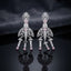 Silver Rose Pink CZ Baguette Crown and Chandelier Fan Jhumka Drop Earrings on dark mirror surface with charcoal fabric backdrop showing rhodium silver grand chandelier jhumka pair with ornate open lotus crown pear white CZ solitaire baguette column open-work fan chandelier body with baguette arch arms 3 tiered jhumka bells and rose pink pear CZ drops