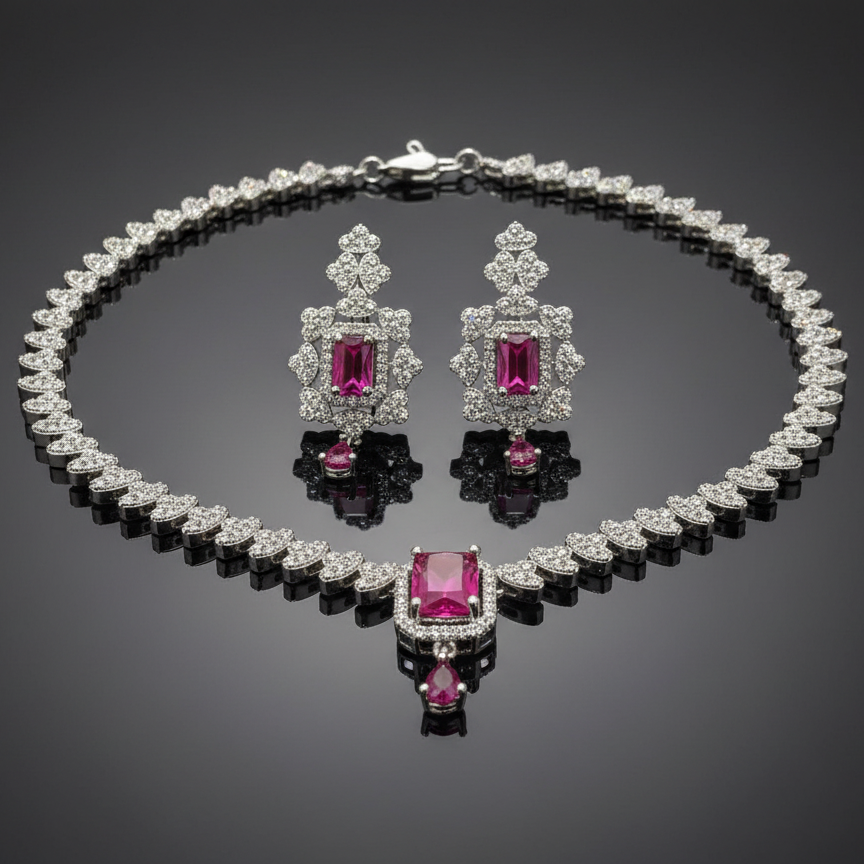 Jewelry set with necklace and earrings featuring pink gemstones on a reflective surface.