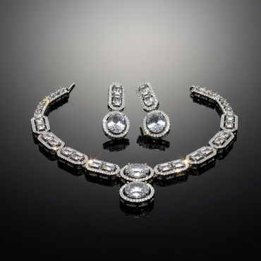 Silver jewelry set with necklace and earrings on a reflective black surface