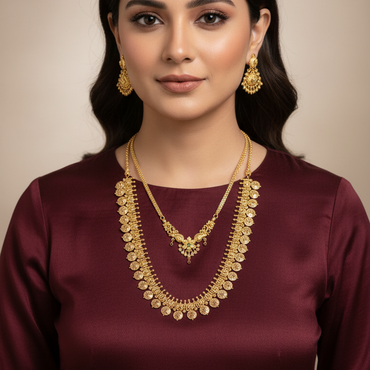 Woman wearing a maroon dress with gold jewelry against a beige background