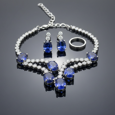 Jewelry set with blue gemstones on a reflective surface