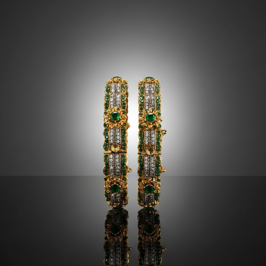 Pair of gold earrings with green and clear gemstones on a reflective surface.