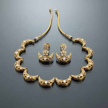 Gold necklace and earrings set on a reflective surface
