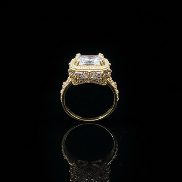 Gold ring with a large central diamond and smaller diamonds on a black background