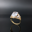 Gold ring with a large diamond on a black background