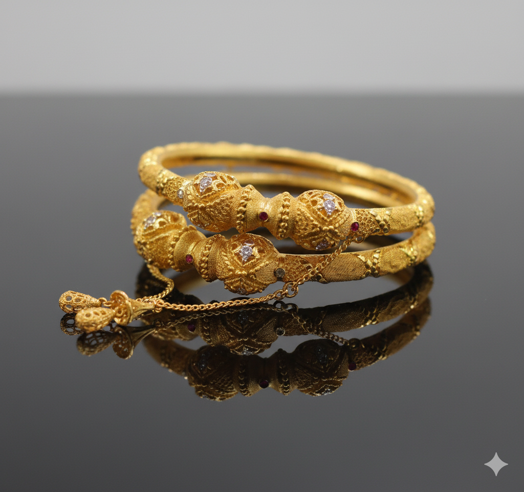 Gold bracelet with intricate design on a reflective surface