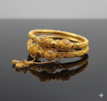 Gold bracelet with intricate design on a reflective surface