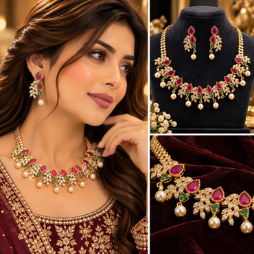 Gold-tone bridal necklace and matching earrings with red and green stones, clear accents, and pearl-style drops