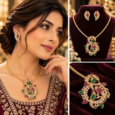 Gold-tone necklace with an ornate red and green accent pendant and matching drop earrings with clear sparkling details