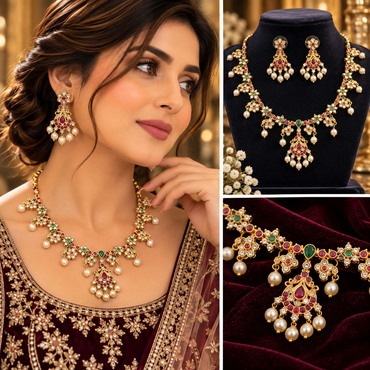 Gold-tone necklace with red and green accents, clear sparkling details, pearl-style drops, and matching drop earrings