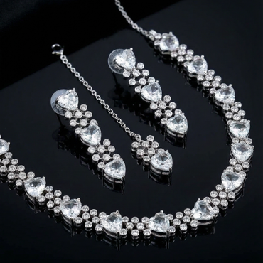 Jewelry set with necklace, bracelet, and earrings on a black background