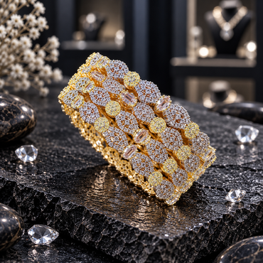 Four matching gold-tone AD bangles with silver-tone floral clear-accent clusters, oval clear accents and smaller round clusters on dark stone.