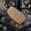 Four matching gold-tone AD bangles with silver-tone floral clear-accent clusters, oval clear accents and smaller round clusters on dark stone.