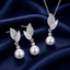 Pearl CZ pave leaf drop pendant necklace and stud earrings set in silver-tone finish with round cream pearl drop and white CZ pave double-leaf top