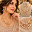 Pink CZ and pearl floral fan bridal necklace and drop earrings set in gold tone displayed on model and jewelry stand