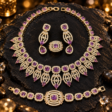 Purple and gold-tone jewellery set featuring an ornate necklace, matching drop earrings, bracelet and ring with clear sparkling details.