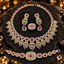 Purple and gold-tone jewellery set featuring an ornate necklace, matching drop earrings, bracelet and ring with clear sparkling details.