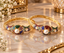 Set of two gold-tone multicolour CZ and pearl traditional bridal bangles with braided herringbone gold band featuring ruby red royal blue emerald green pink aqua and champagne CZ stone clusters with large cream pearl centrepiece displayed on marble surface with white flowers and gold decor
