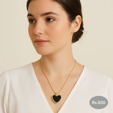 Black enamel heart pendant necklace in gold-tone on model – Destiny.pk