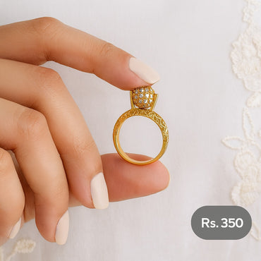 Gold-tone pavé dome ring with engraved band held between fingers – Destiny.pk”