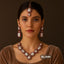 Gold-tone pearl & ruby bridal necklace set with earrings and tikka on model – Destiny.pk