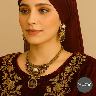 Antique gold black stone necklace set with pearl accents and matching earrings on model – Destiny.pk