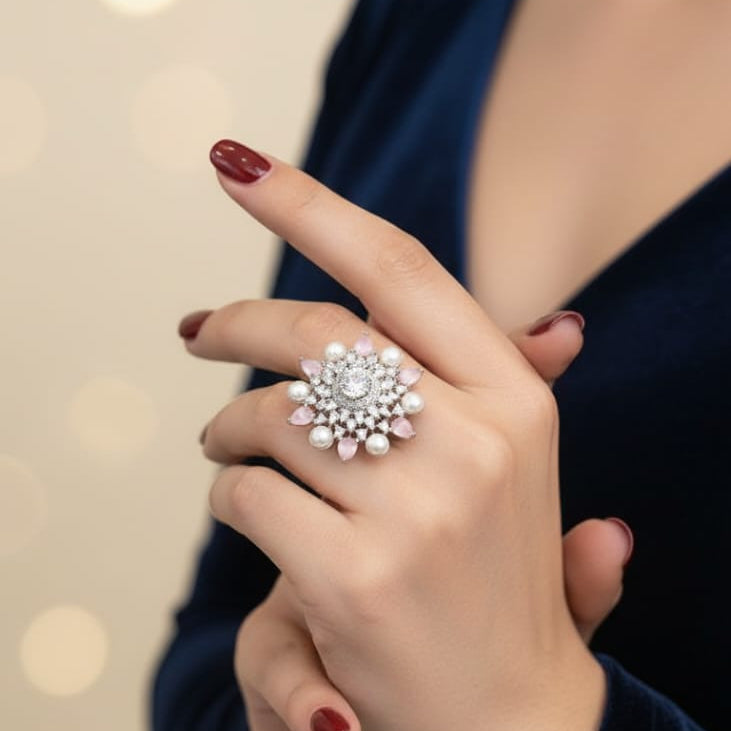 Hand wearing a decorative ring with a blurred background and '1950' text.