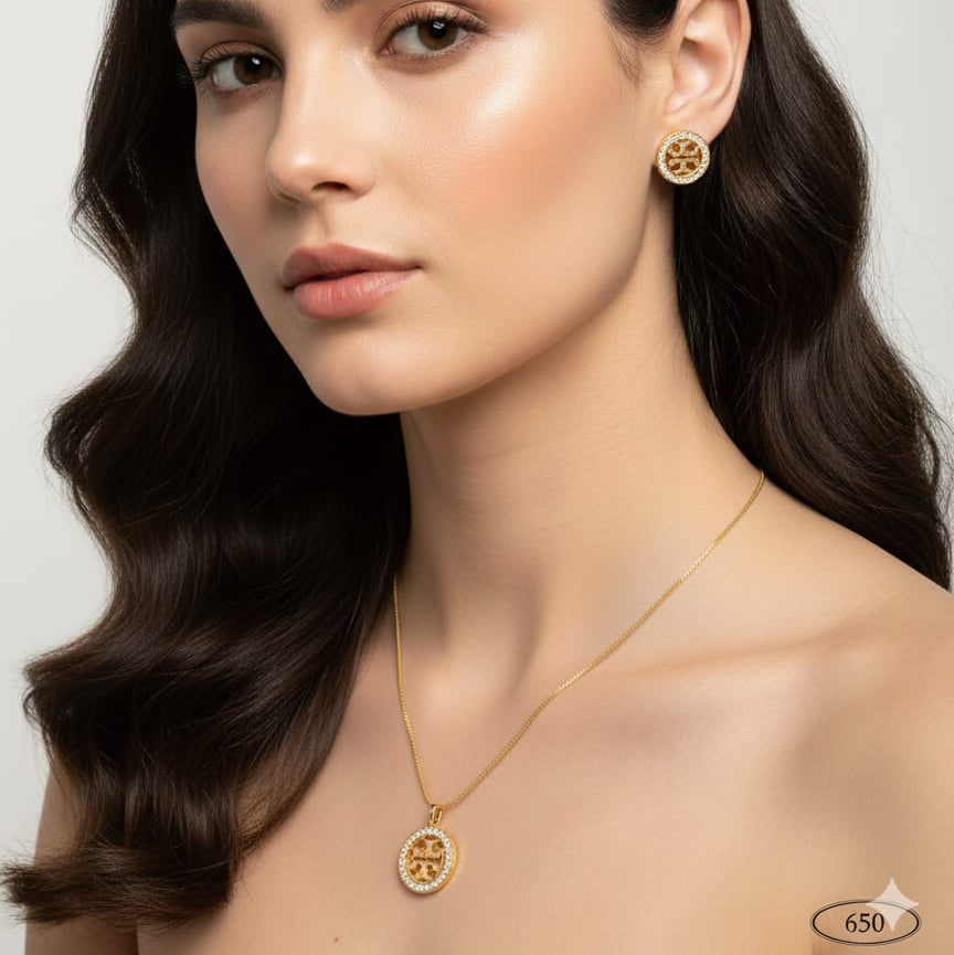 Woman wearing gold necklace and earrings on a plain background