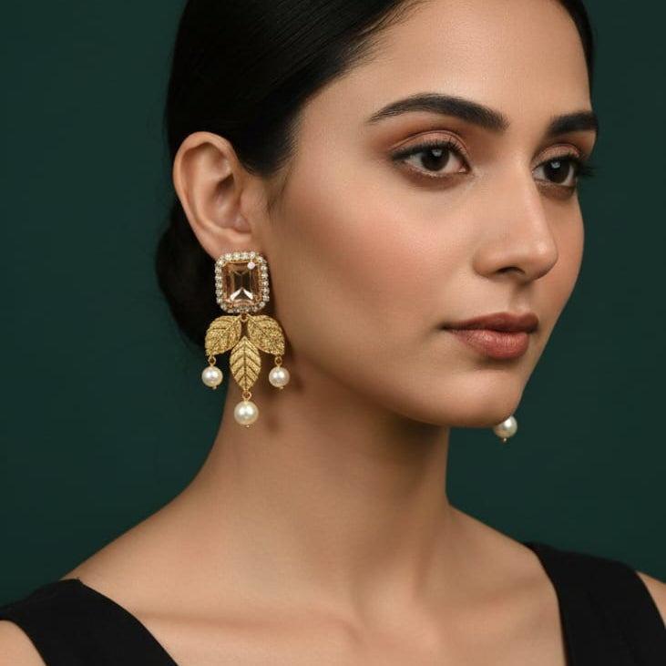 Traditional gold-toned champagne stone leaf pearl earrings, priced Rs. 1150